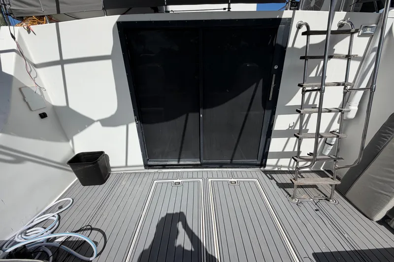Slide: The Image of 1987 Bluewater Yachts Coastal Cruiser 51 deck with ladder and sliding door. - 22