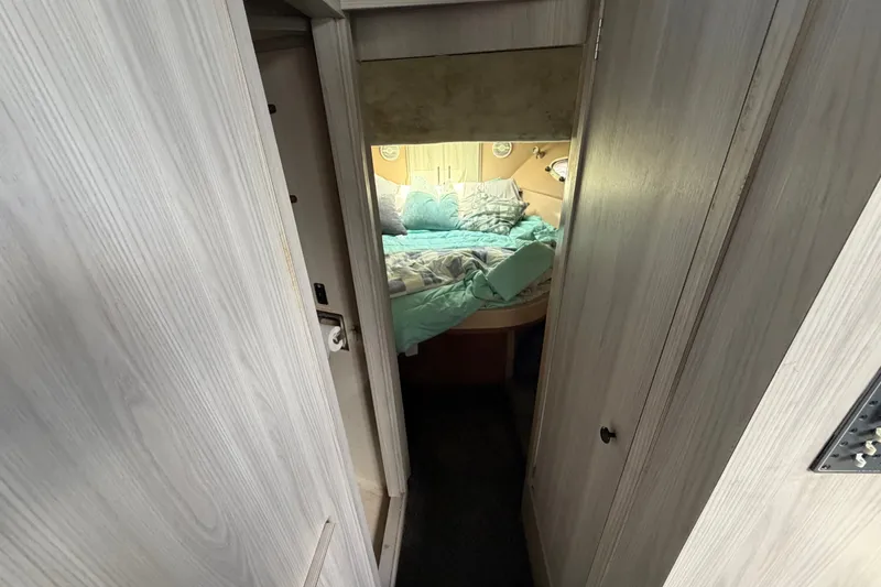 Slide: The Image of Interior view of 1987 Bluewater Yachts Coastal Cruiser 51, featuring a cozy bedroom. - 44