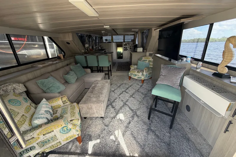 Slide: The Image of Interior of 1987 Bluewater Yachts Coastal Cruiser 51, featuring cozy seating and large windows. - 24