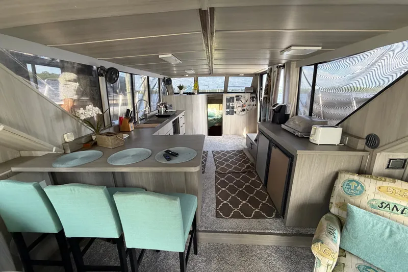 Slide: The Image of Interior of 1987 Bluewater Yachts Coastal Cruiser 51, featuring modern kitchen and seating area. - 35