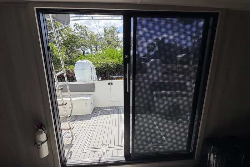Slide: The Image of 1987 Bluewater Yachts Coastal Cruiser 51 deck view through sliding door. - 31