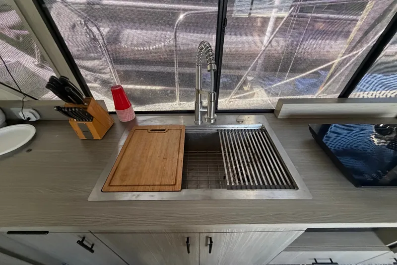 Slide: The Image of Modern kitchen sink area in 1987 Bluewater Yachts Coastal Cruiser 51. - 40