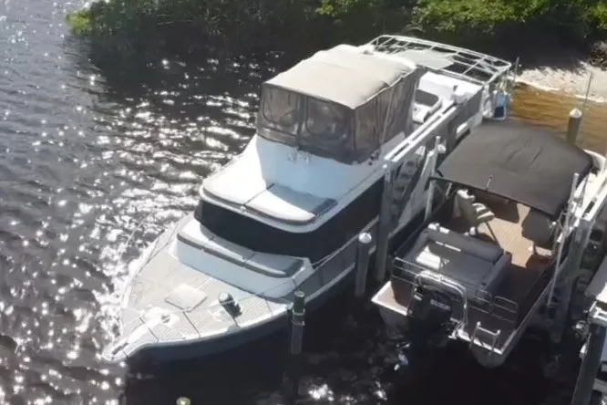 Slide: The Image of 1987 Bluewater Yachts Coastal Cruiser 51 docked on a sunny day. - 6
