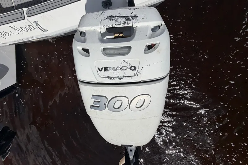 Slide: The Image of Outboard motor on a 1987 Bluewater Yachts Coastal Cruiser 51, docked on water. - 17