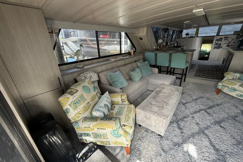 Slide: The Image of Interior of 1987 Bluewater Yachts Coastal Cruiser 51, featuring cozy seating and modern decor. - 25
