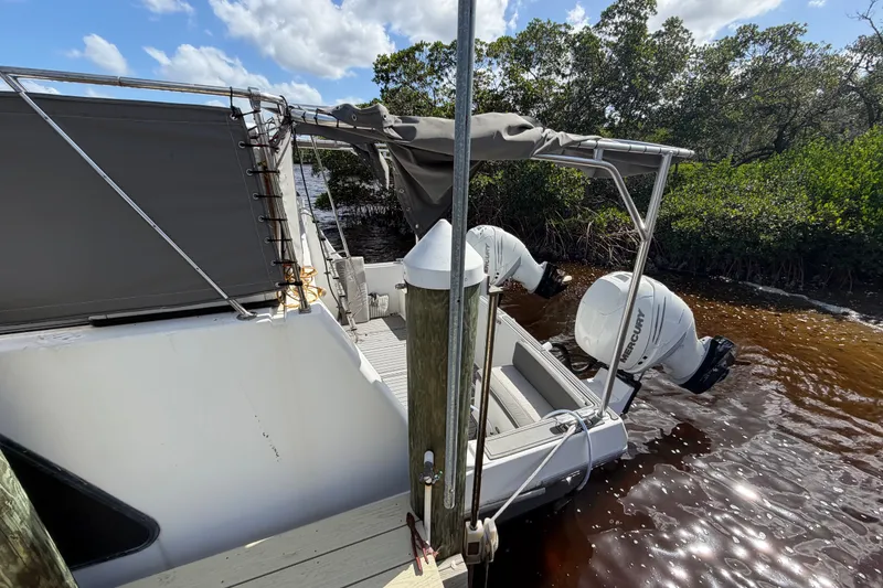 Slide: The Image of 1987 Bluewater Yachts Coastal Cruiser 51 docked, featuring dual Mercury outboard engines. - 8