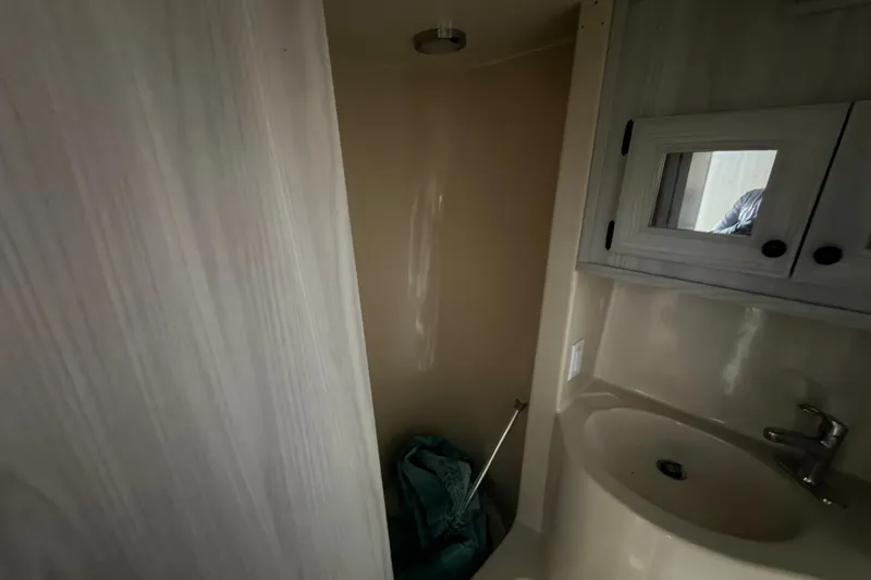 Slide: The Image of Bathroom interior of 1987 Bluewater Yachts Coastal Cruiser 51, featuring sink and shower. - 47