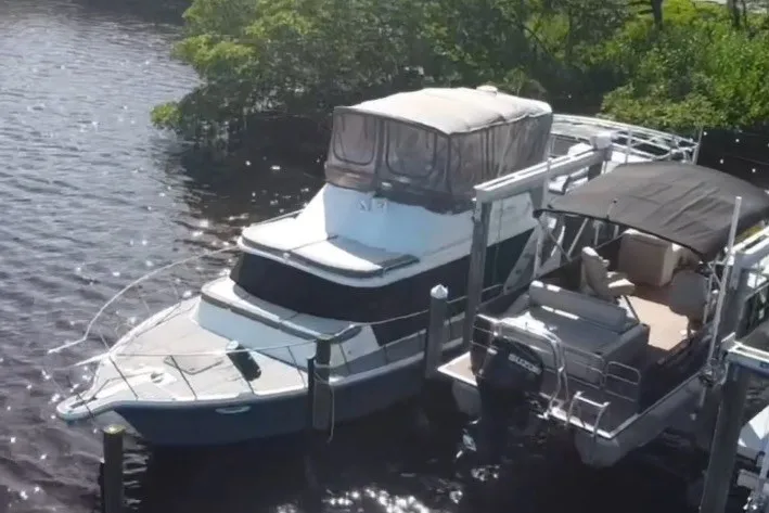 Slide: The Image of 1987 Bluewater Yachts Coastal Cruiser 51 docked on a sunny day. - 7