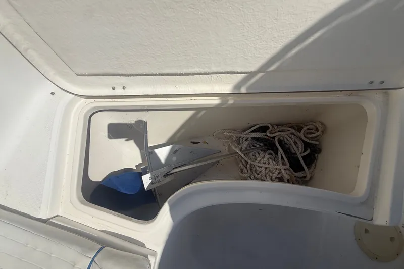 Slide: The Image of An open storage compartment on a boat with ropes and an anchor inside. - 37