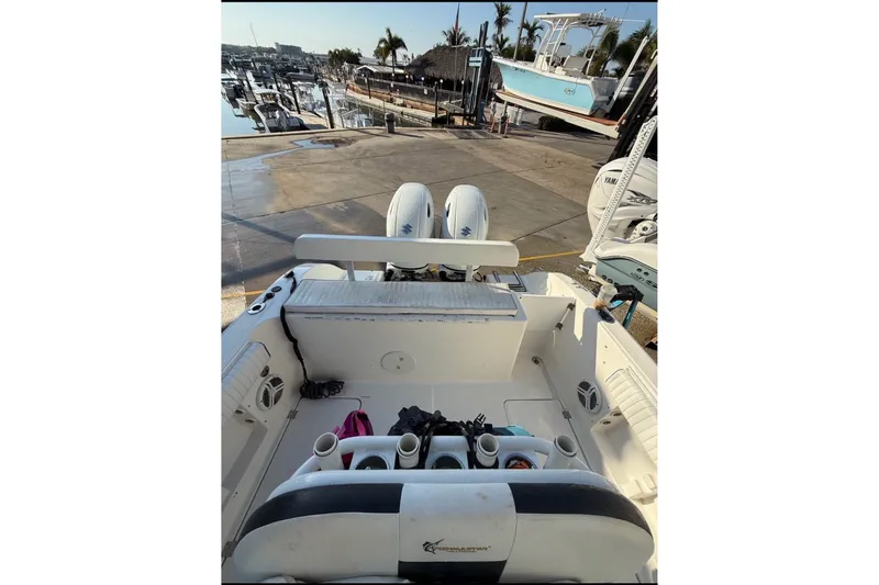 Slide: The Image of A 2004 Sea Fox 257 Center Console boat on a trailer in a harbor area. - 2