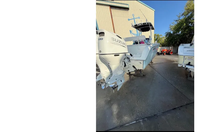 Slide: The Image of A 2004 Sea Fox 257 Center Console boat with Suzuki outboard engines. - 1