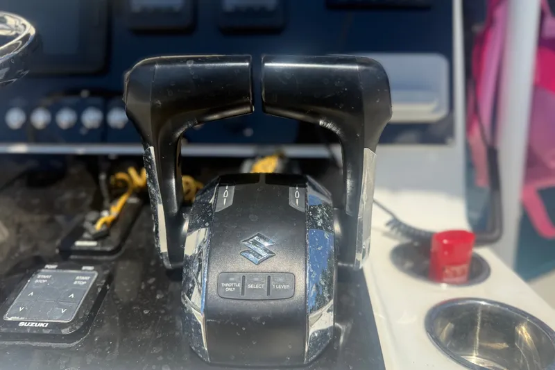 Slide: The Image of Throttle controls on a 2004 Sea Fox 257 Center Console boat dashboard. - 27