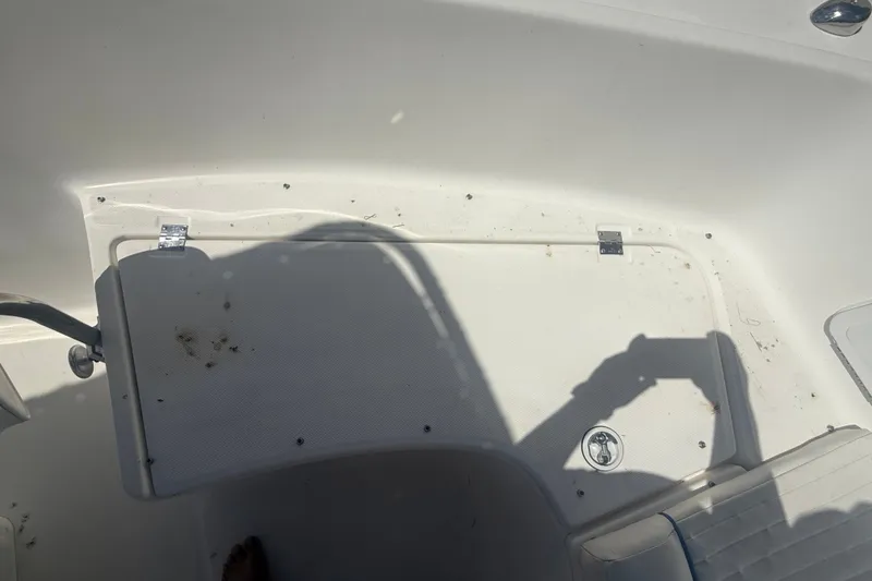 Slide: The Image of 2004 Sea Fox 257 Center Console boat interior with storage compartment and seating. - 34
