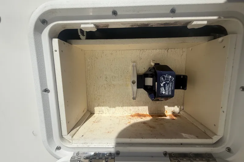 Slide: The Image of Storage compartment on a 2004 Sea Fox 257 Center Console boat, featuring a mounted device. - 54