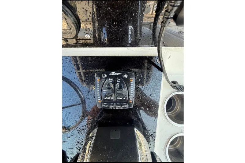 Slide: The Image of Close-up of a control panel with switches and cup holders on a boat. - 7
