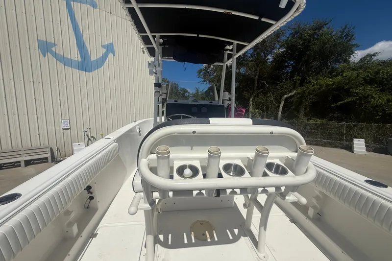 Slide: The Image of 2004 Sea Fox 257 Center Console boat with rod holders, docked near a building. - 18