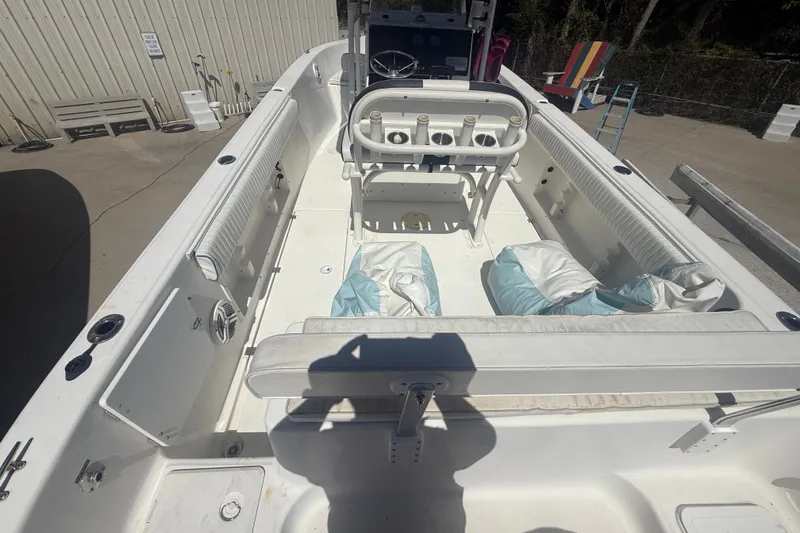 Slide: The Image of 2004 Sea Fox 257 Center Console boat interior with seating and storage compartments. - 16