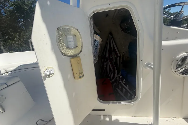 Slide: The Image of Open storage compartment on a 2004 Sea Fox 257 Center Console boat. - 30