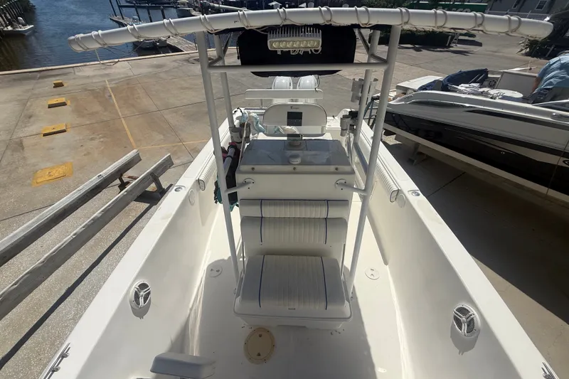 Slide: The Image of 2004 Sea Fox 257 Center Console boat docked, showcasing spacious deck and seating area. - 40