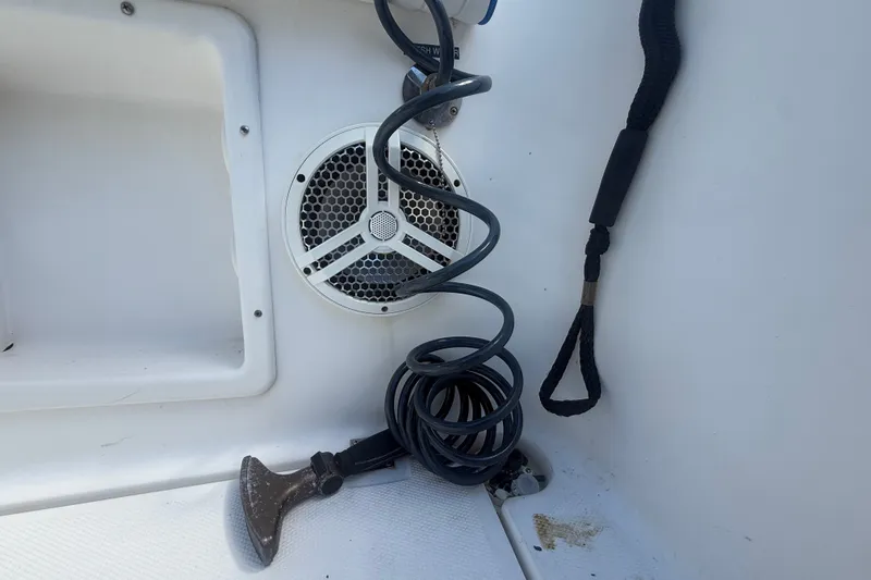 Slide: The Image of Coiled cable and speaker on 2004 Sea Fox 257 Center Console boat interior. - 49