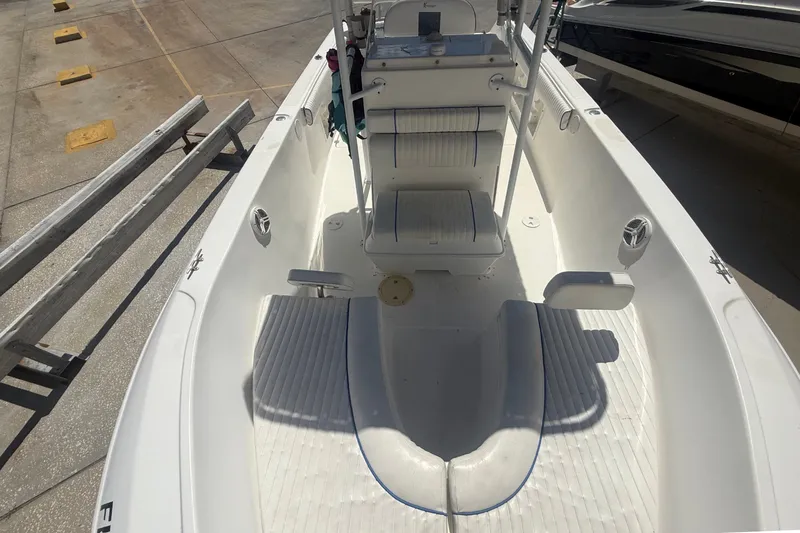 Slide: The Image of A 2004 Sea Fox 257 Center Console boat with a clean, spacious deck and helm console. - 39