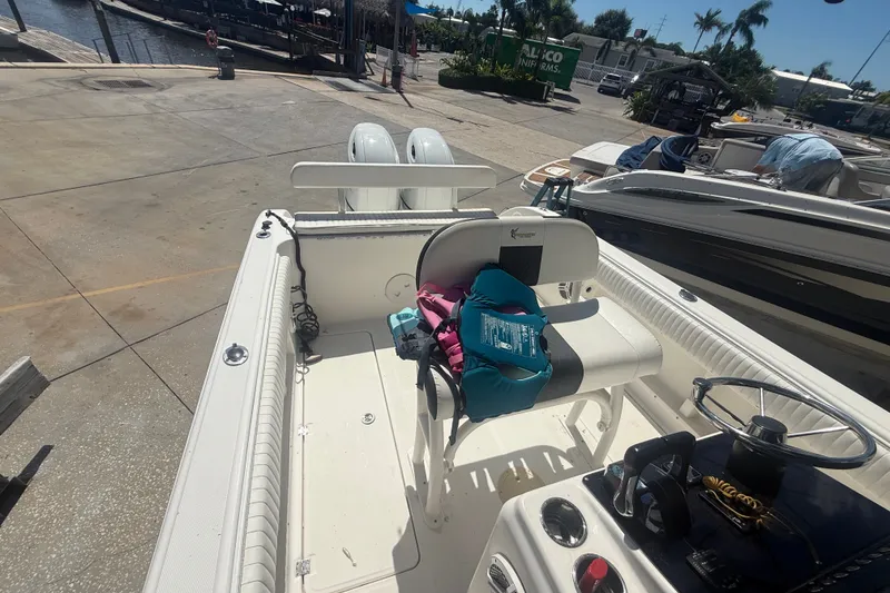 Slide: The Image of 2004 Sea Fox 257 Center Console boat docked, featuring seating and life jackets. - 43