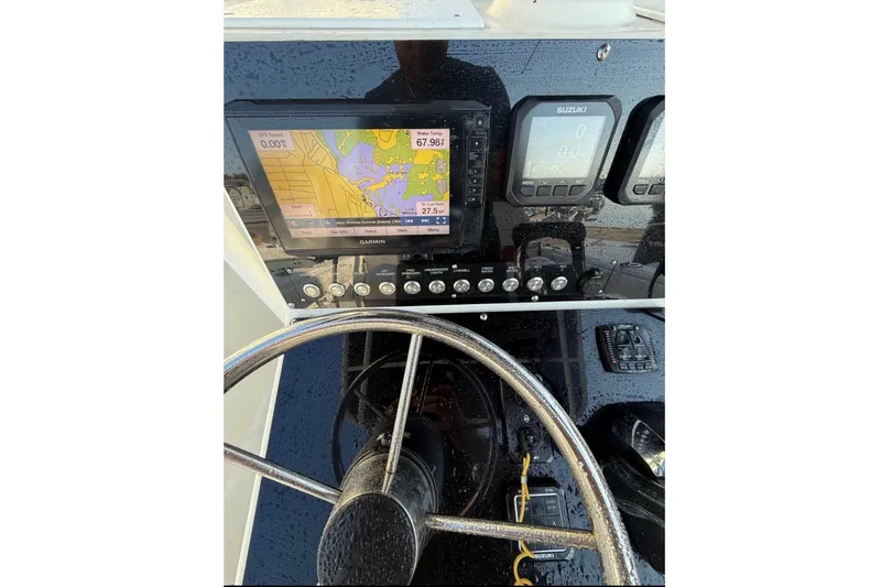 Slide: The Image of The image shows the dashboard of a Sea Fox 257 Center Console boat with navigation equipment. - 8