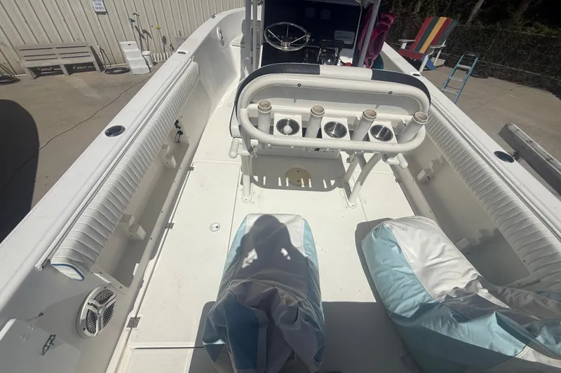 Slide: The Image of 2004 Sea Fox 257 Center Console boat interior with rod holders and seating. - 17
