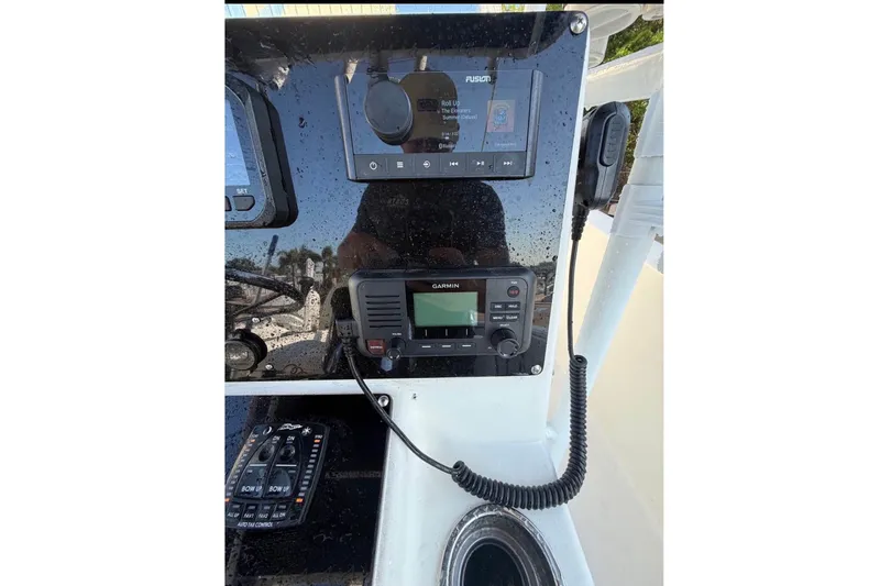 Slide: The Image of The image shows the dashboard of a 2004 Sea Fox 257 Center Console boat with electronic equipment. - 6