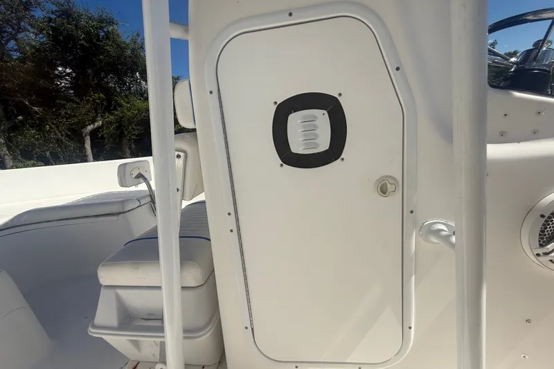 Slide: The Image of 2004 Sea Fox 257 Center Console boat interior with seating and storage compartment. - 29