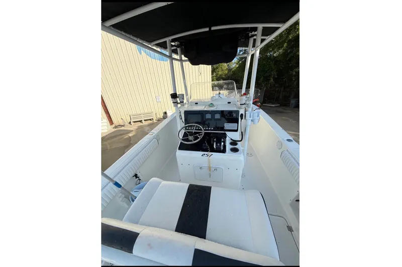 Slide: The Image of Interior view of a 2004 Sea Fox 257 Center Console boat with helm and seating. - 3