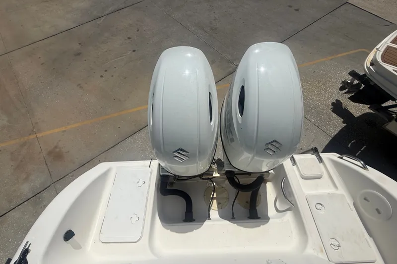 Slide: The Image of Twin Suzuki outboard motors on a 2004 Sea Fox 257 Center Console boat. - 52