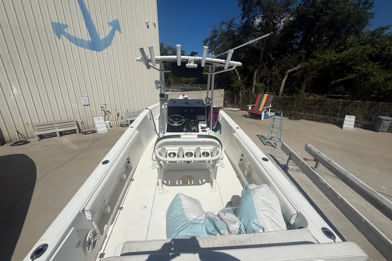 Slide: The Image of 2004 Sea Fox 257 Center Console boat docked, featuring spacious deck and steering console. - 15