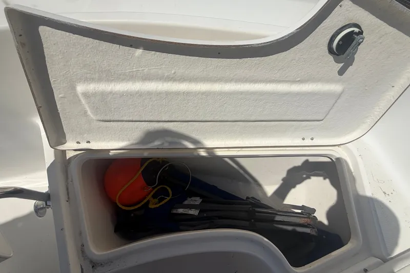 Slide: The Image of Open storage compartment on 2004 Sea Fox 257 Center Console boat with equipment inside. - 35