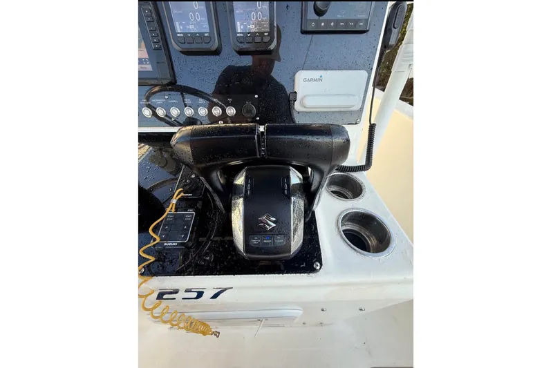 Slide: The Image of The image shows the helm of a 2004 Sea Fox 257 Center Console boat with Suzuki controls. - 10