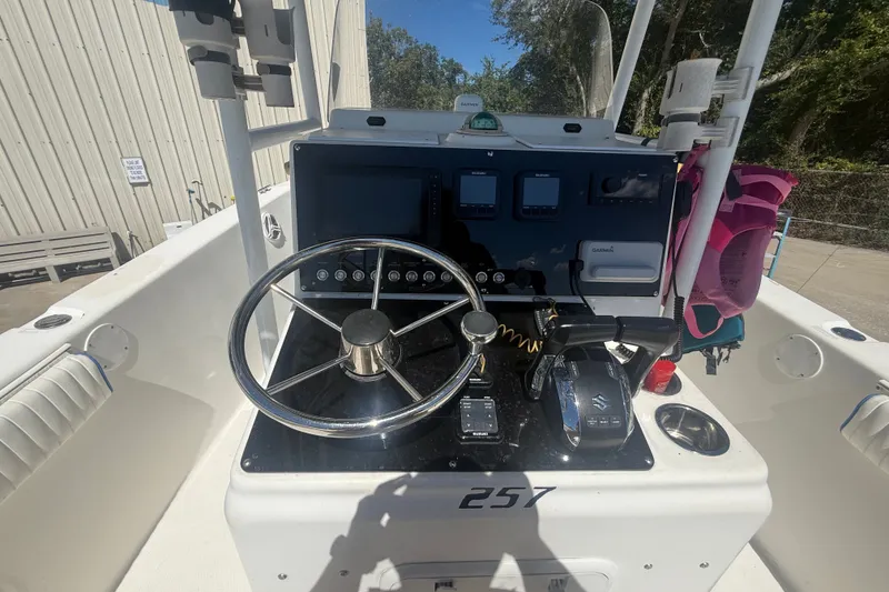 Slide: The Image of 2004 Sea Fox 257 Center Console boat dashboard with steering wheel and controls. - 20