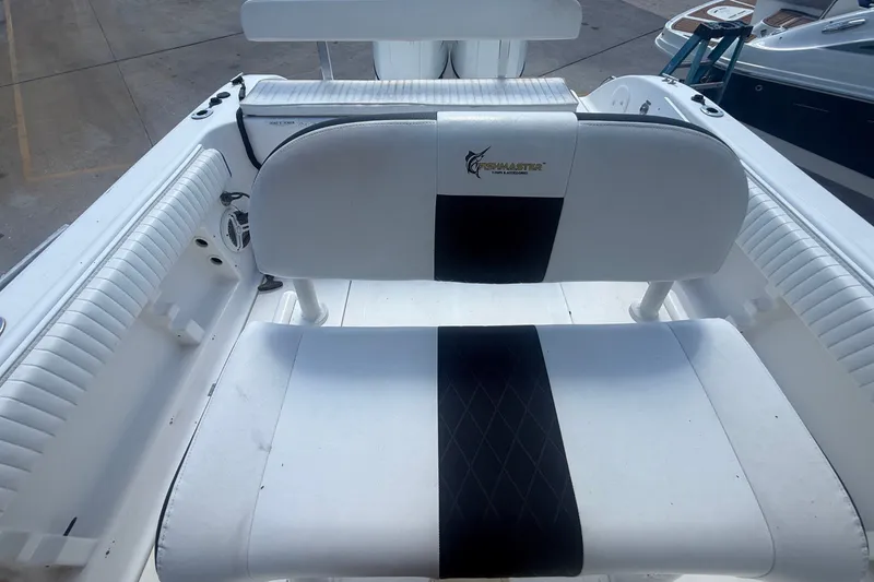 Slide: The Image of The image shows a white bench seat with a black center stripe on a boat. - 46