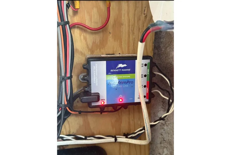 Slide: The Image of A Bennett Marine AutoTrim Pro control unit is mounted on a wooden board, surrounded by wires. - 12