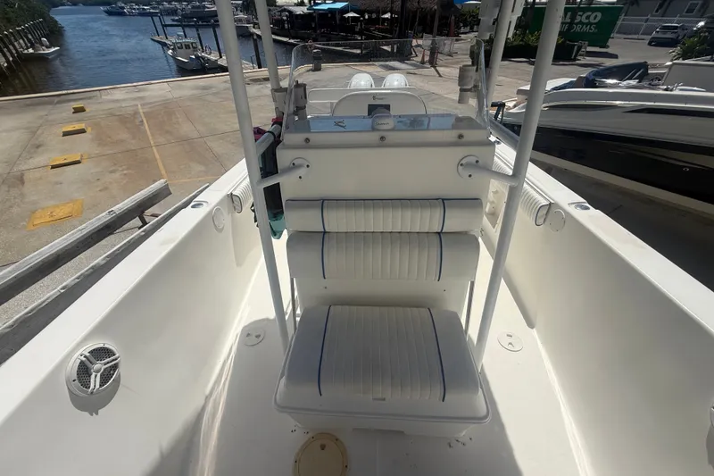 Slide: The Image of 2004 Sea Fox 257 Center Console boat interior with seating and marina view. - 41