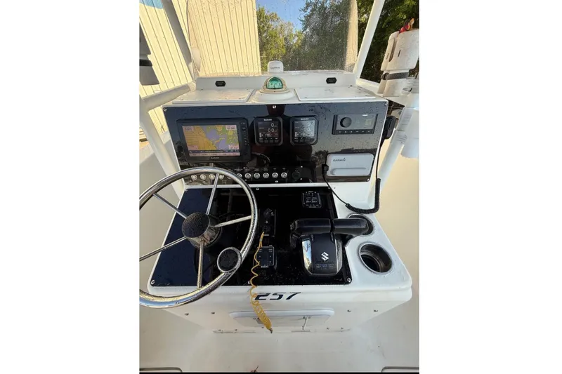 Slide: The Image of The image shows the helm of a 2004 Sea Fox 257 Center Console boat. - 4