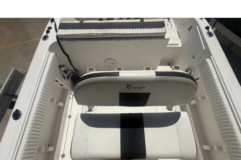 Slide: The Image of The image shows the cockpit of a 2004 Sea Fox 257 Center Console boat with cushioned seating. - 45