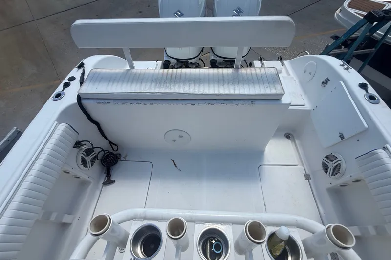 Slide: The Image of The image shows the cockpit of a 2004 Sea Fox 257 Center Console boat with fishing rod holders. - 47