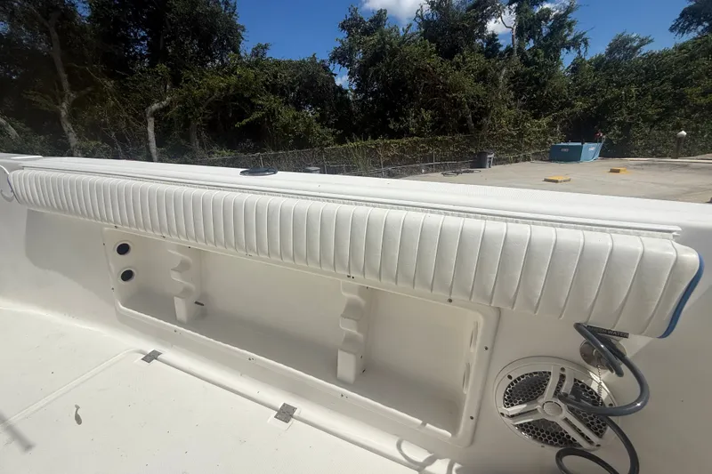 Slide: The Image of 2004 Sea Fox 257 Center Console boat interior with white cushioned seating and speaker. - 51