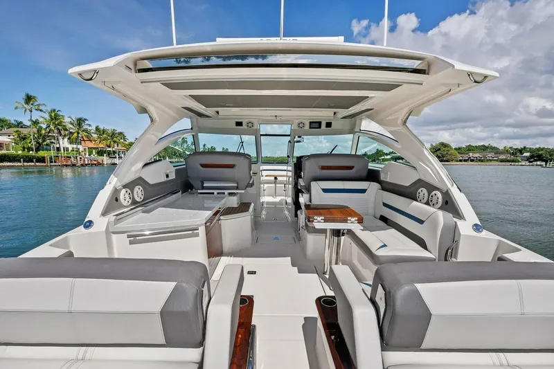 Slide: The Image of Luxurious 2020 Tiara 38 LX yacht interior with plush seating and scenic waterfront view. - 16