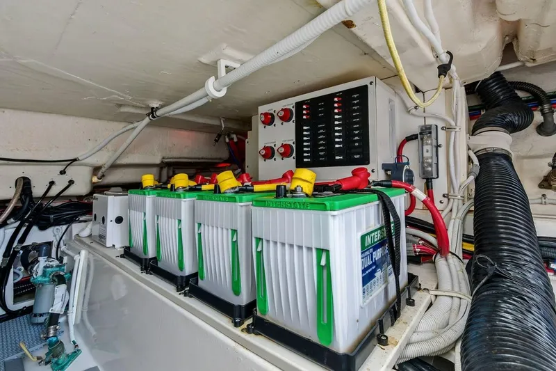 Slide: The Image of Battery compartment of a 2020 Tiara 38 LX boat, featuring multiple Interstate batteries. - 32