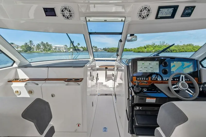 Slide: The Image of Interior view of 2020 Tiara 38 LX yacht cockpit with navigation screens and steering wheel. - 28