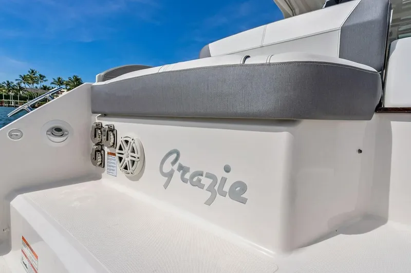 Slide: The Image of 2020 Tiara 38 LX boat with "Grazie" name, featuring sleek seating and ocean backdrop. - 15