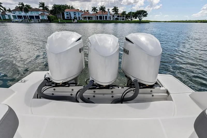 Slide: The Image of Triple Yamaha outboard engines on a 2020 Tiara 38 LX boat, with waterfront homes in the background. - 24