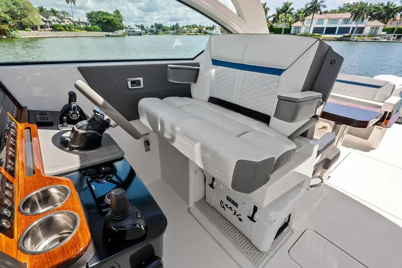 Slide: The Image of Luxurious helm seating on a 2020 Tiara 38 LX yacht with modern controls and scenic water view. - 26