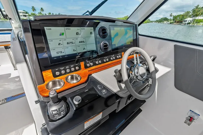 Slide: The Image of Helm of 2020 Tiara 38 LX yacht with advanced navigation displays and controls. - 25